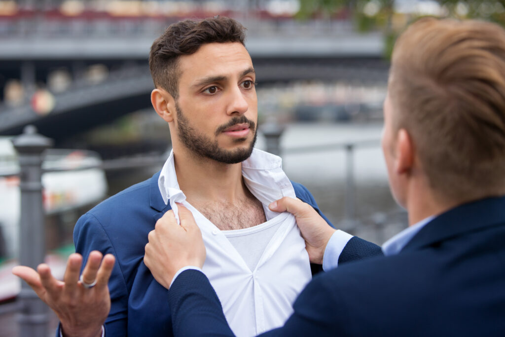 two young businessmen having a fight outside