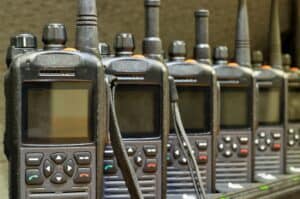 Black walkie talkies lined up in a row