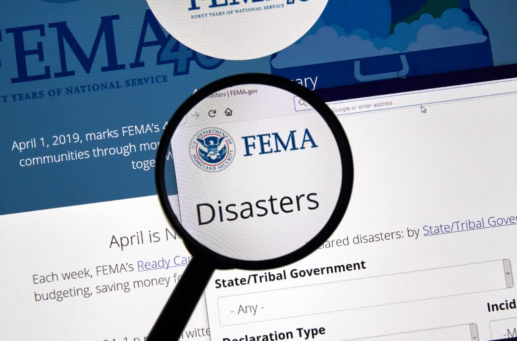Fema.gov Disasters USA Government home page under magnifying glass. FEMA is The Federal Emergency Management Agency