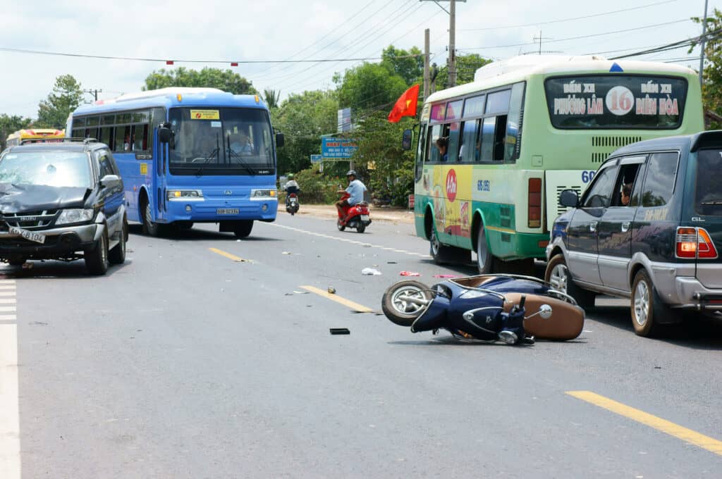 DONG NAI, VIET NAM- MAY 1: Traffic accident on highway 20, crowded of Vietnamese people on street, car crash with motorbike, crashed car, motorcycle lay on street, unsafe traffic, Vietnam, May 1, 2015