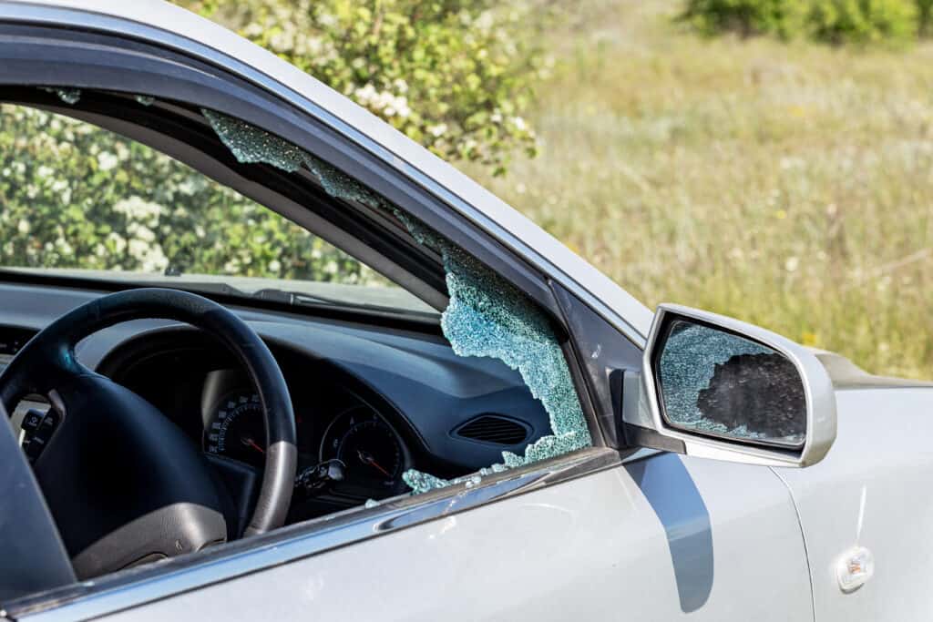 Criminal incident. Hacking a car. church vandalism. Broken driver's side window of car. Thieves smashed window of car with fragments inside, glass was scattered throughout. Crime - broken window and theft belongings